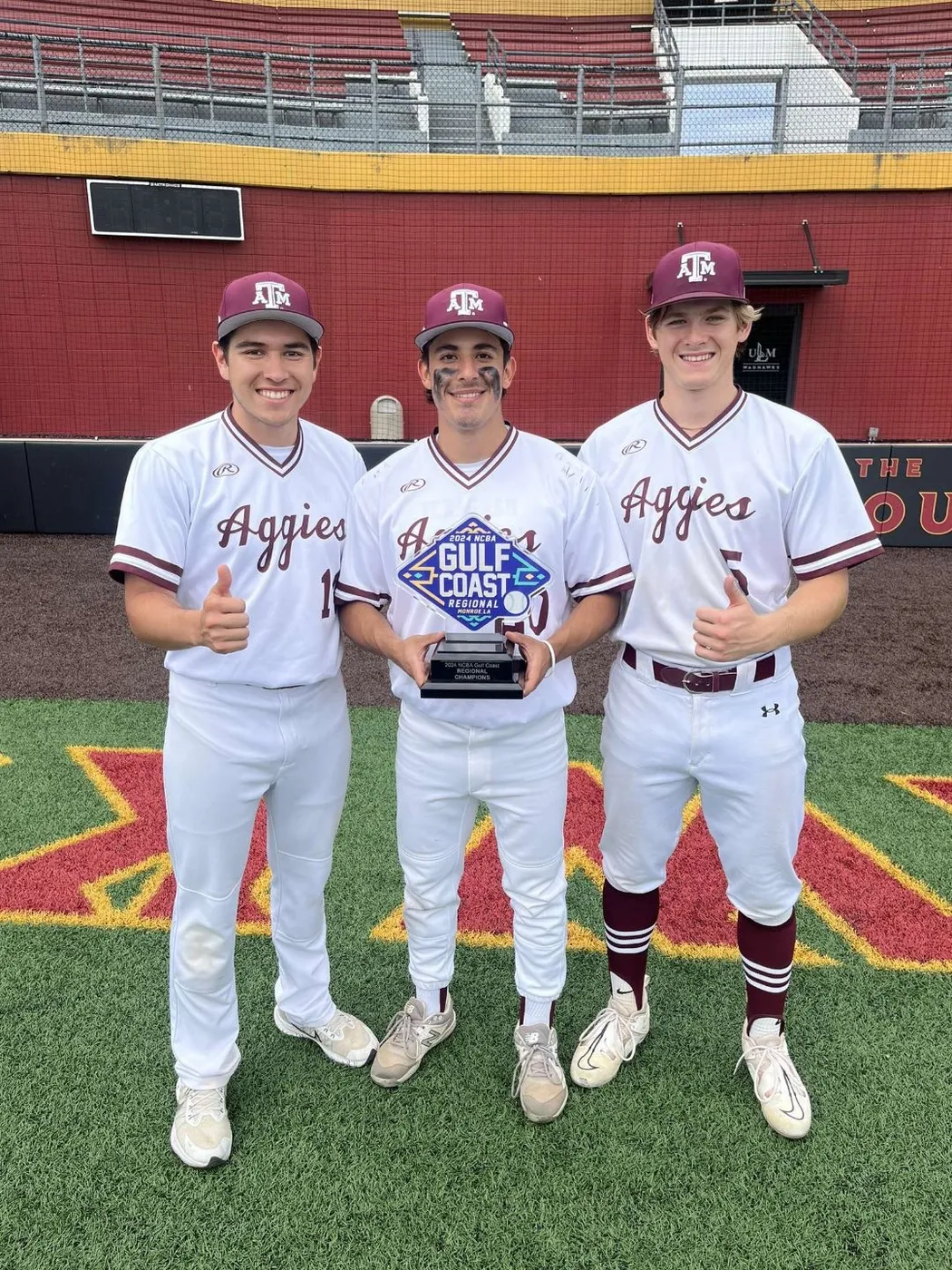Iron Spikes members in Aggie Club Baseball uniforms holding a trophy