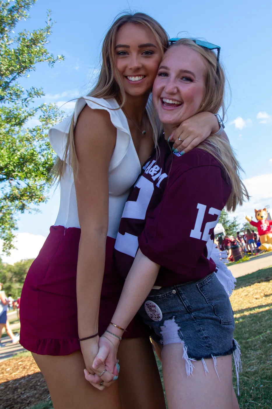 Two Iron Spikes Sweethearts in Aggie gear on game day